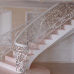 Openwork forged railings for concrete stairs